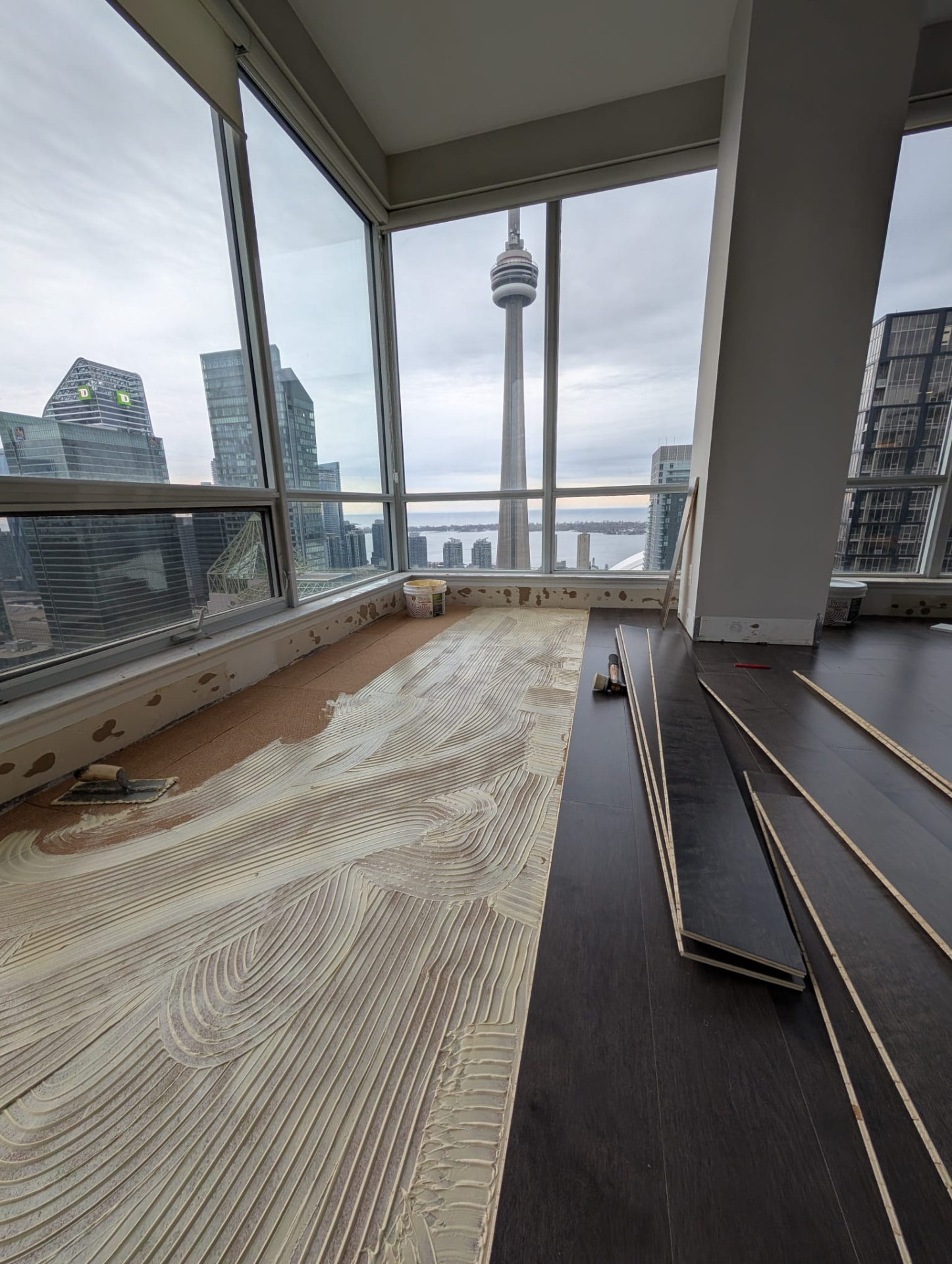 Adhesive applied across a prepared subfloor in a downtown Toronto condominium